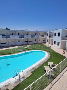 a large swimming pool in front of a building at Casa Nalu - Costa Calma Sun & Pool in Costa Calma