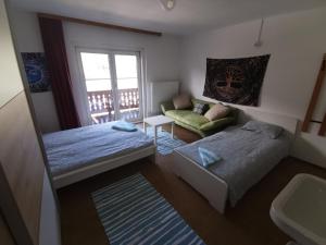 a small bedroom with a bed and a couch at Bike hostel Schladming in Schladming