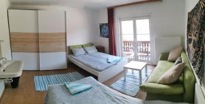 a living room with a couch and a bed at Bike hostel Schladming in Schladming