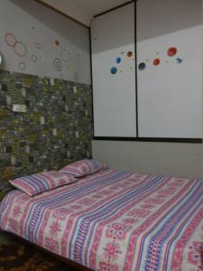 a bedroom with a bed with pillows and a cabinet at Love homestay CT in Kangar