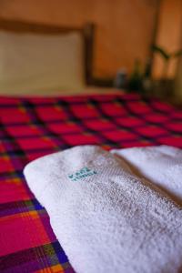 two white towels sitting on top of a table at Kara-Tunga Safari Camp in Moroto