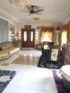 a living room with a couch and a table at Love homestay CT in Kangar