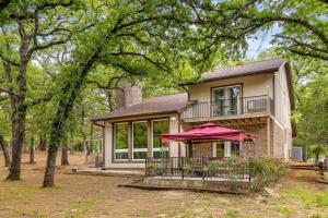 a house with a red umbrella in front of it at Woodlands Vacation Home in Little Elm/ Frisco TX in Little Elm