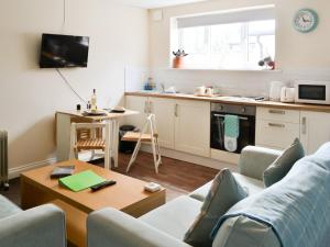 a living room with a couch and a table at Cygnet Cottage - Uk43546 in Belford