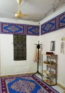 a room with a wall with a window and a rug at Love homestay CT in Kangar