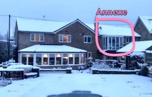 a house in the snow with a red circle around it at Lovely two bedroom Annexe close to Newbury 