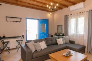 a living room with a couch and a table at Family holiday home 'Arokaria' in Skaládhos
