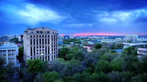 a view of a city with buildings and trees at Xata 1+2 in Almaty