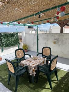 a table and four chairs on a patio at Piero's Home in Castellana Grotte