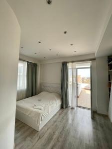 a bedroom with a bed and a large window at dream villa in Tbilisi City