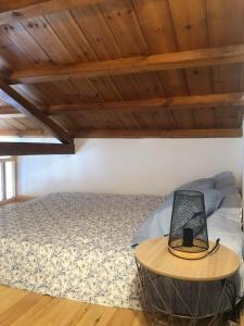 a bedroom with a bed and a table with a laptop on it at Avgoustina's Home in Glossa