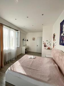a bedroom with a large bed and a window at dream villa in Tbilisi City