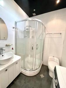 a bathroom with a glass shower and a toilet at dream villa in Tbilisi City