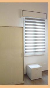 a room with a window and a door and a white box at B&B Nuova Salento in Grottaglie