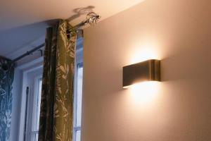 a light on a wall next to a window at Stunning flat in Brighton & Hove - Central luxury. in Brighton & Hove