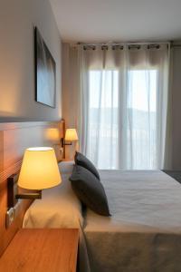 Posteľ alebo postele v izbe v ubytovaní Aparthotel Cal Marçal