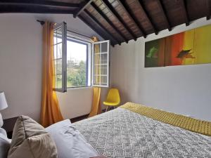 a bedroom with a bed and a window at Vila Mendonça in Povoação