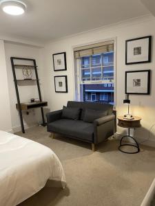 a living room with a couch and a bed at Studio flat in the heart of St. Johns Wood in London