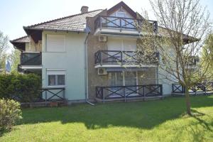 a house with black railings on the side of it at Victoria Wave Apartman in Balatonőszöd