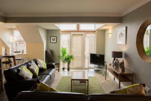 a living room with a couch and a tv at No 1 Kennington Court in Llandudno