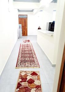a hallway with rugs on the floor in a house at NYALI LUXURY APARTMENT in Mombasa