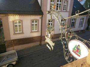 a sign in front of a building with a house at Hotel Strauss in Waldbronn