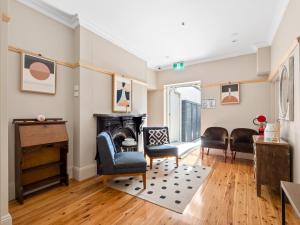 a living room with a fireplace and chairs at VENUS Surry Hills - FEMALE ONLY HOSTEL - Long stay negotiable in Sydney
