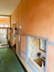 a room with a window with flowers on the wall at Hotel de la Sologne in Beaugency