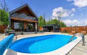 a house with a swimming pool in front of it at Lovely Home In Ferdinandovac With Jacuzzi in Ferdinandovac
