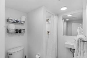 a bathroom with a toilet and a sink and a mirror at Columbia City Urban Studio in Seattle