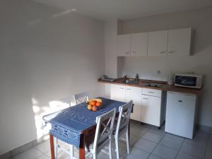 a kitchen with a table with chairs and a blue table sidx sidx sidx at Apartment Klementina FREE PARKING in Zagreb