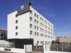 a large building with a clock on the front of it at Ibis Budget Madrid Vallecas in Madrid