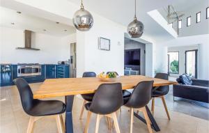 a kitchen and dining room with a wooden table and chairs at Amazing Home In Ador With Kitchenette in Ador