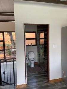 a bathroom with a toilet in a room at Sun Room (Studio) on the edge of the Harties dam. in Hartbeespoort