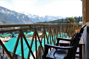 a balcony with a view of a swimming pool at UpClimb Longstay for bus or taxi only guests in Manāli