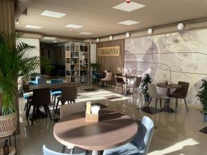 a restaurant with tables and chairs in a restaurant at Apart-hotel 24/7 in Kamianets-Podilskyi