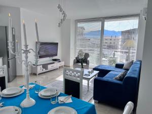 a living room with a blue couch and a blue table at White Luxury in Shkodër