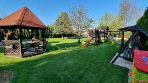 a park with a playground with a gazebo at PanOli Apartmanház Nyíregyháza in Nyíregyháza