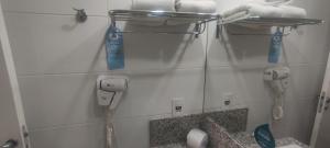 a bathroom with a phone hanging on the wall at Apartamento San Diego Pampulha Propriedade Particular in Belo Horizonte +13 photos