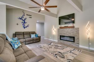 a living room with a couch and a fireplace at Serene Lakefront Mountain Home Getaway with Atrium! in Mountain Home