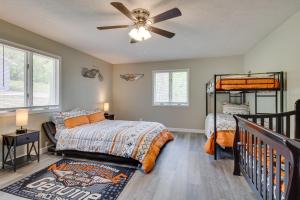 a bedroom with two beds and a ceiling fan at Serene Lakefront Mountain Home Getaway with Atrium! in Mountain Home