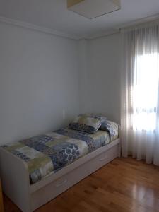 łóżko w białym pokoju z oknem w obiekcie La LLamosa Beach&Nature w mieście Galizano