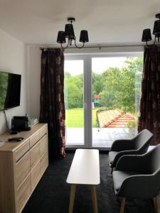 a living room with a large sliding glass door at Galleria Betliar in Betliar