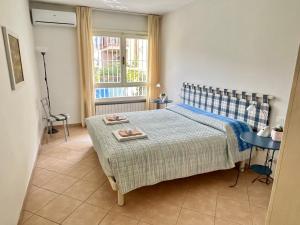 a bedroom with a bed with a table and a window at Apartment Bardolino lake front in Bardolino
