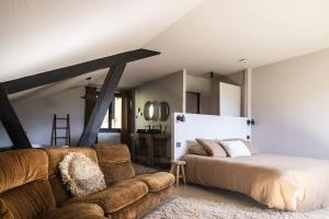 a bedroom with a bed and a couch at Chalet d'Albiez in Albiez-Montrond