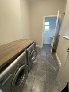 a washer and dryer in a room with a door at Extra large 6 bed 7 bath townhouse in Manchester in Manchester