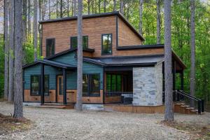 a house in the middle of the forest at Brand New Luxury 2 Bedroom with Loft and Spa Sleeps 10 in Broken Bow