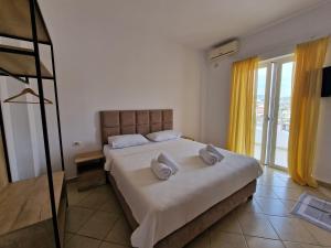 a bedroom with a bed with two pillows on it at Studio Eno Ksamil in Ksamil