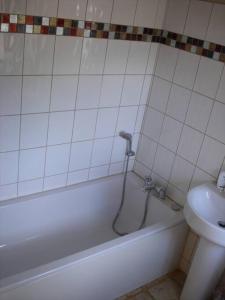 a bathroom with a tub and a toilet and a sink at Creedy Meadow Barn in Crediton