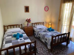 A bed or beds in a room at ''Mary's House'' Entire residence Olympiada Halkidiki Near to Sea 200m !